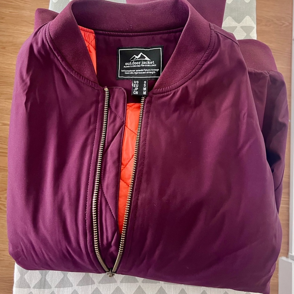 Heavily stylish burgundy color bomber jacket, size small for sale